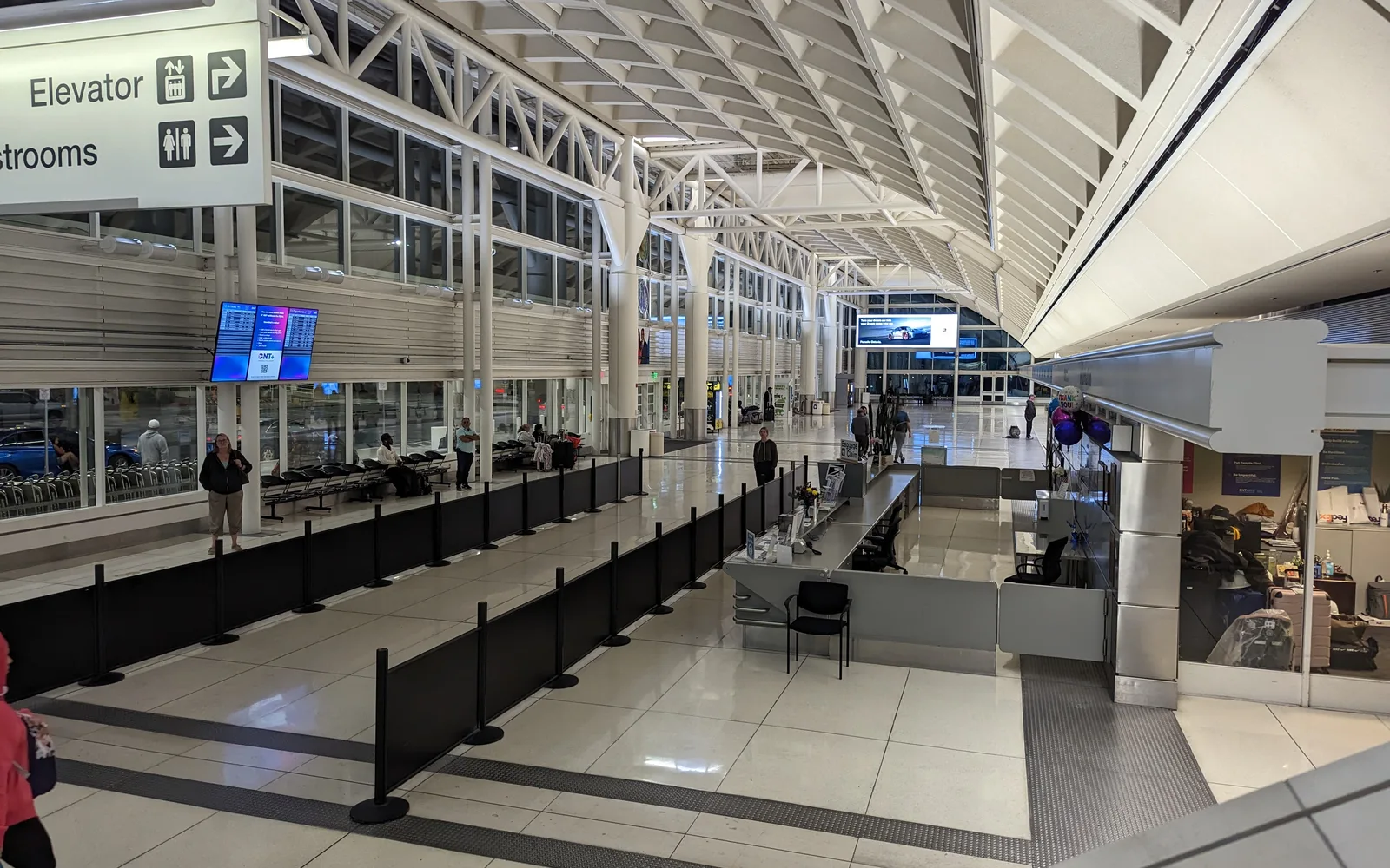 Interior of Ontario International Airport Terminal 2, showing modern architecture and departure area with blue seating